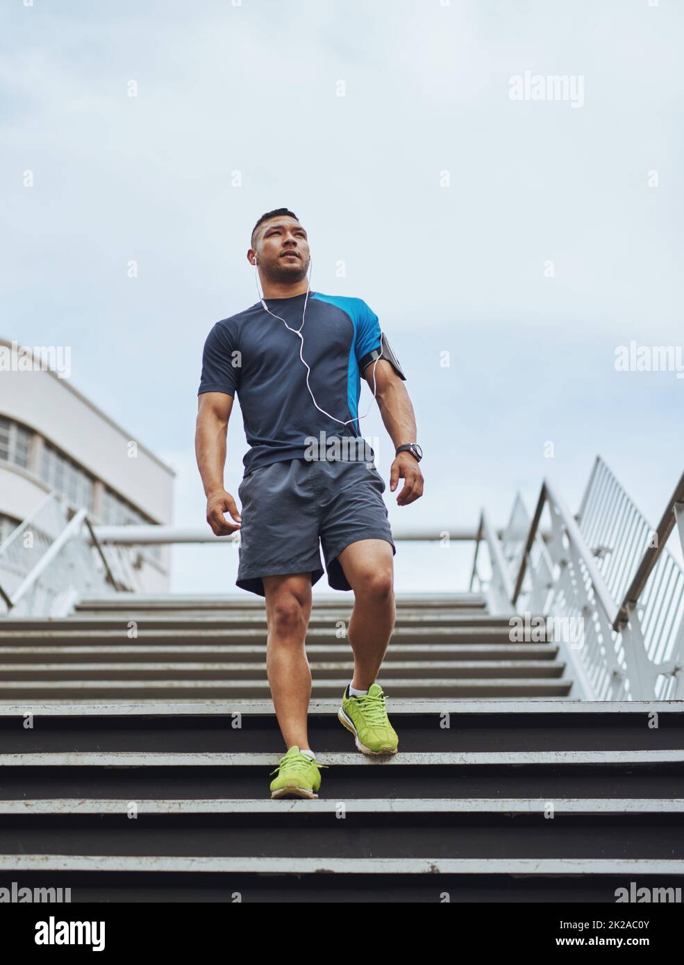 Time for some serious exercise. Low angle shot of a young man out for a run in the city. Stock Photo