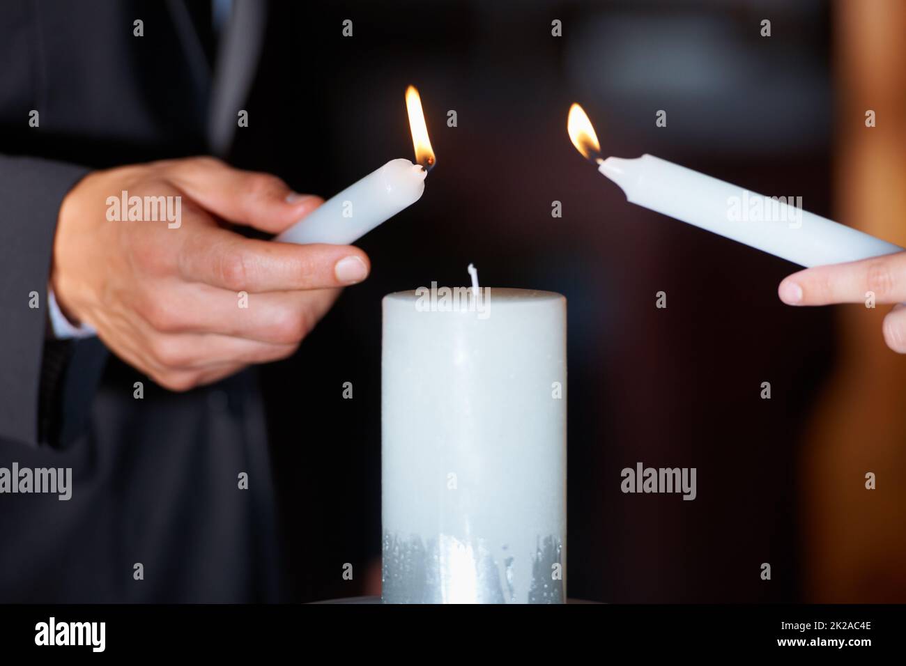 The flame of their love. Closeup shot of a couple lighting candles