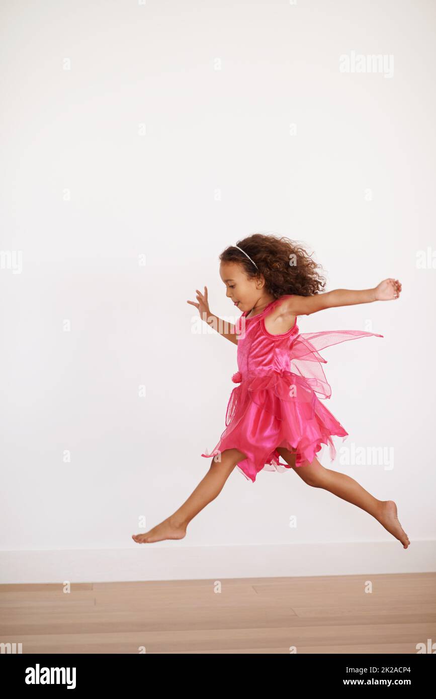 Sugar rush. Cropped shot of an exuberant little girl running indoors. Stock Photo