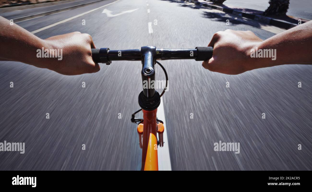 Living life behind bars. POV shot of a person riding a bicycle along a road  Stock Photo - Alamy