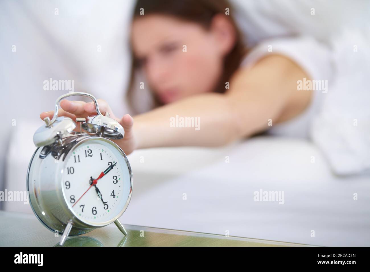Not yet. A young woman pressing the stop button on her alarm clock