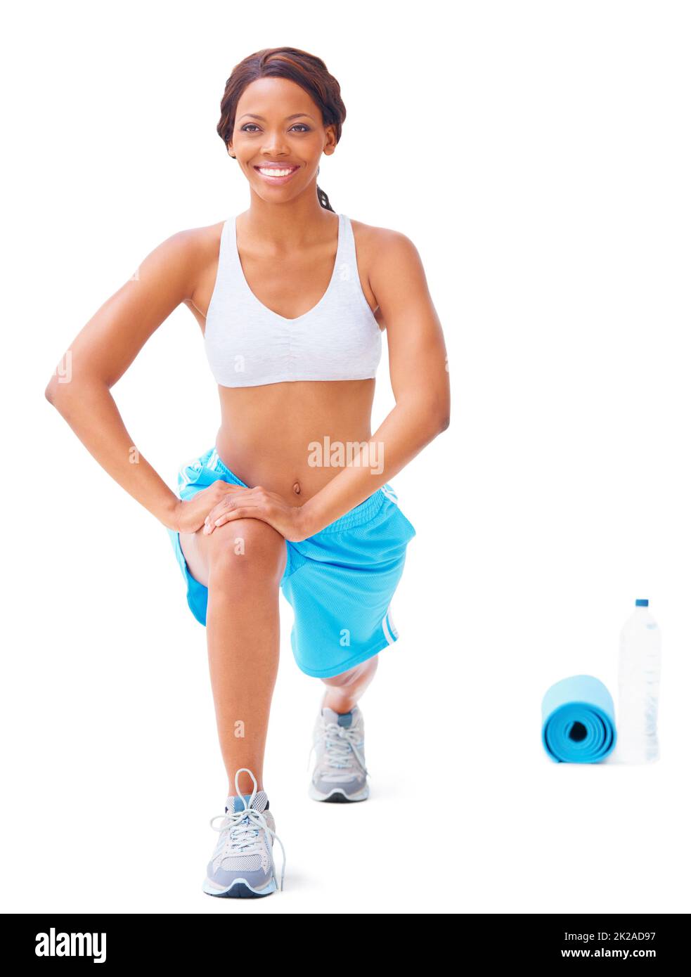 Stretching those muscles. Young african american woman stretching against a white background. Stock Photo
