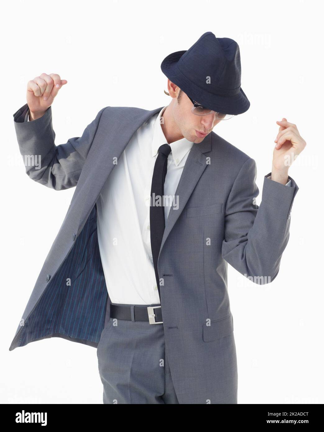man standing in formal clothes, suspenders making poses with his suit  (photo 1/6) Stock Photo
