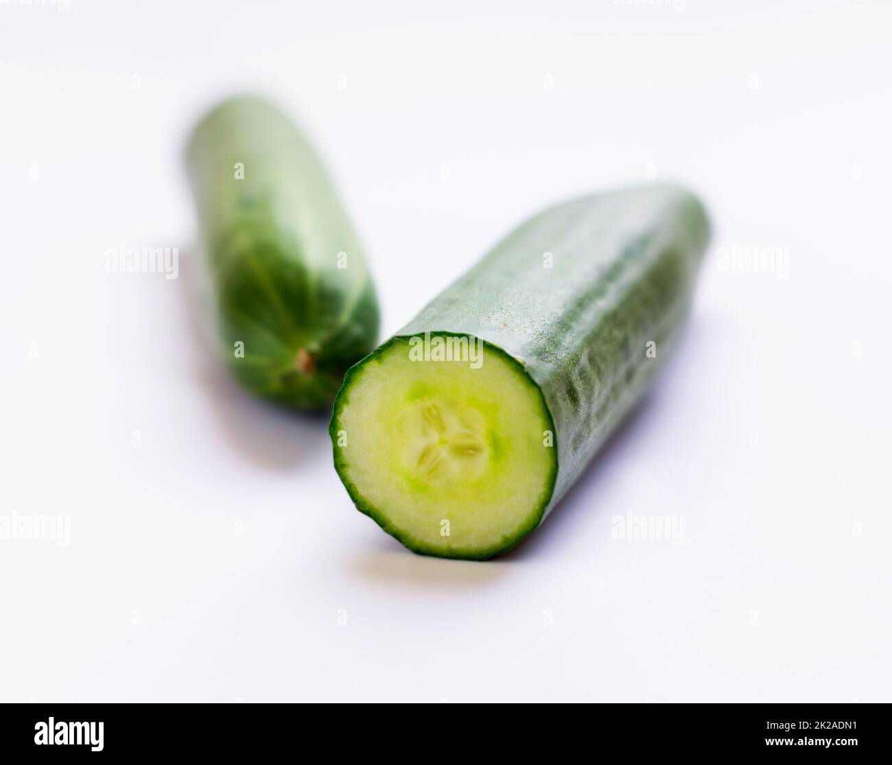IT goes perfect with any salad. Closeup studio shot of cut cucumber. Stock Photo
