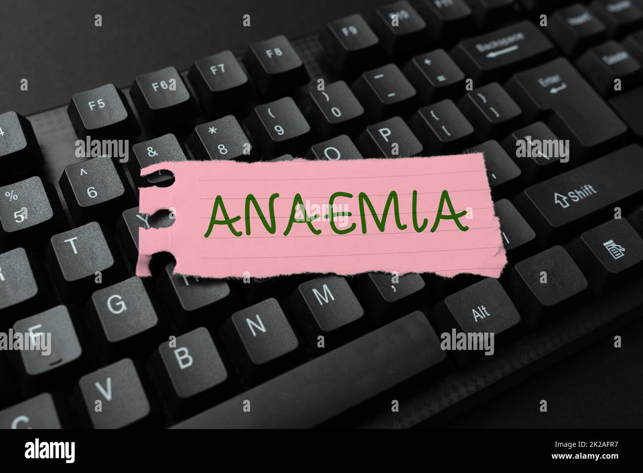 Handwriting text Anaemia. Word Written on a condition marked by a deficiency of hemoglobin in the blood Editing And Retyping Report Spelling Errors, Typing Online Shop Inventory Stock Photo
