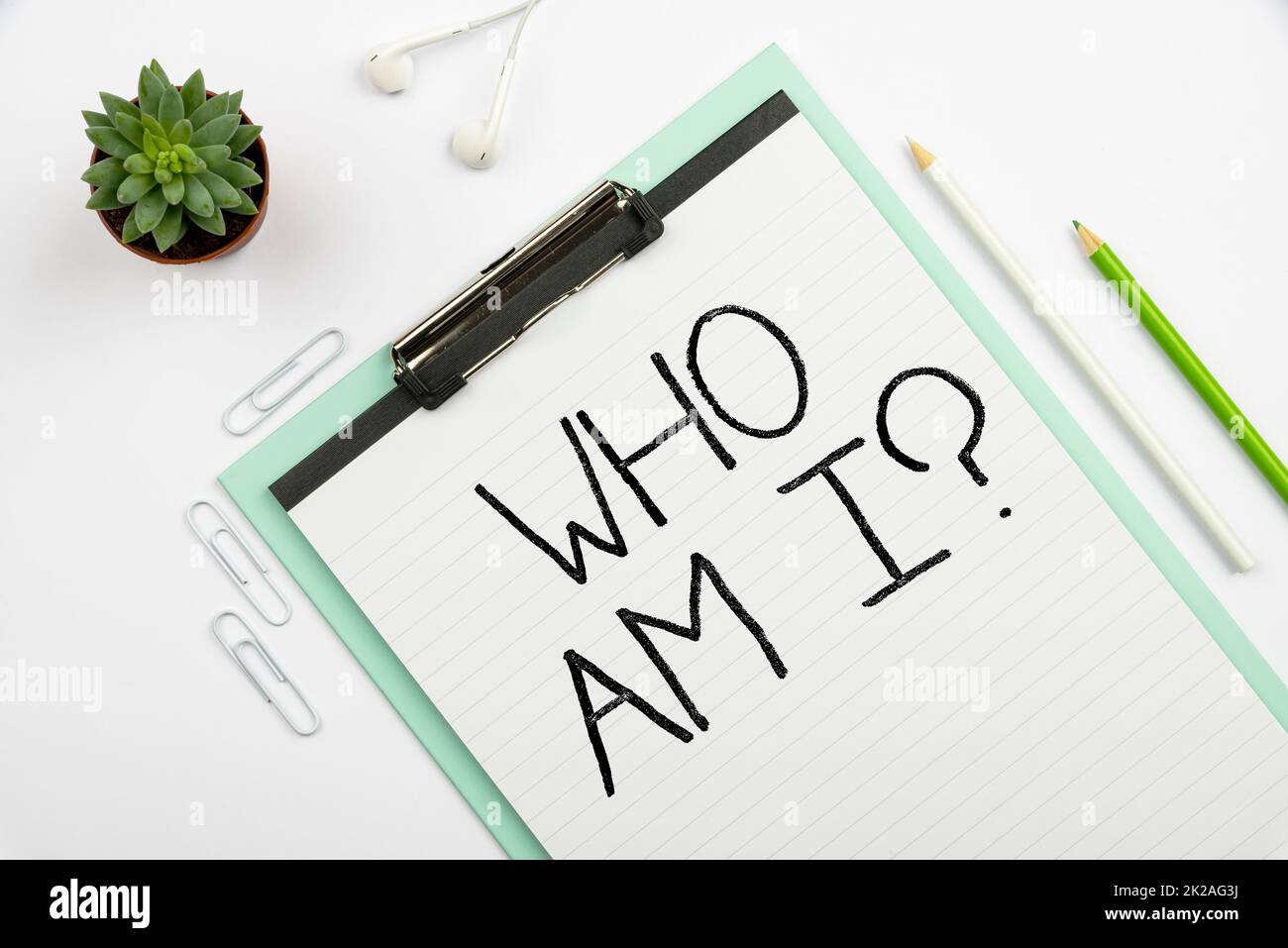 Hand writing sign Who Am I Question. Business showcase asking about self identity or personal purpose in life Multiple Assorted Collection Office Stationery Photo Placed Over Table Stock Photo