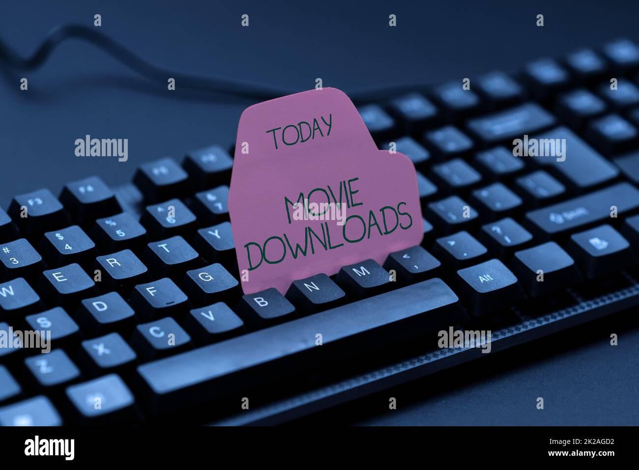 Writing displaying text Movie Downloads. Business idea transfers entire film for local storage and later use Typing Program Schedule, Retyping And Debugging Program String Codes Stock Photo