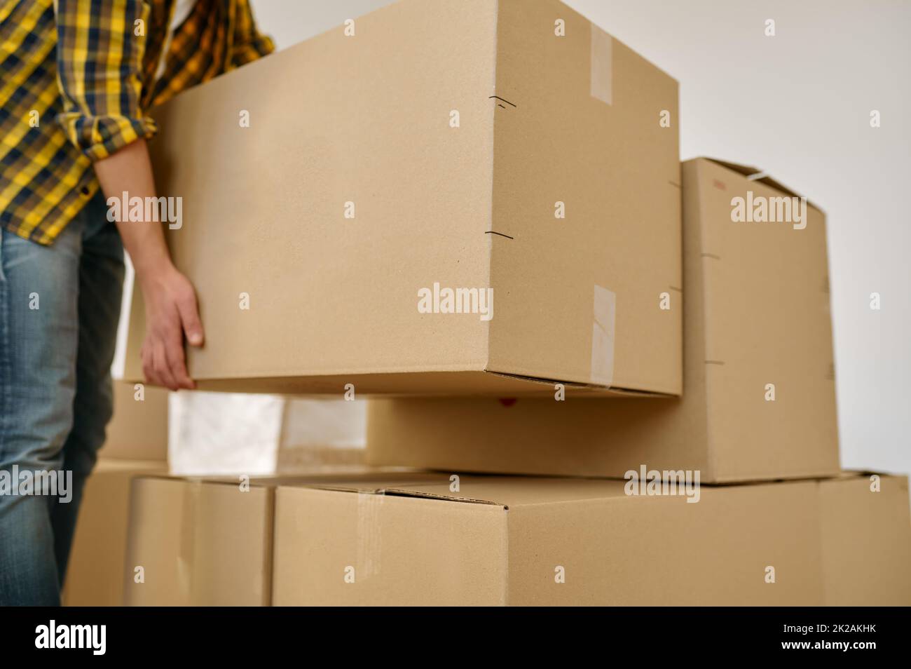 Closeup hand lifting box during home moving Stock Photo