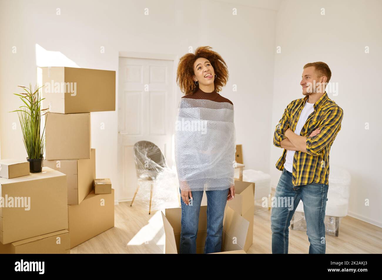 Newlyweds fooling around while moving to house Stock Photo - Alamy