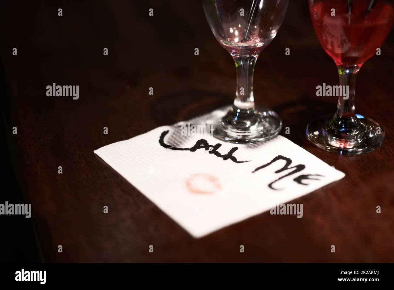 Get the message. Closeup of a flirtatious message written on a napkin on a bar counter. Stock Photo