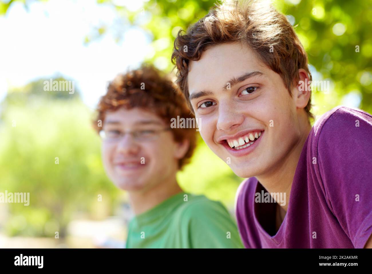 Hanging out with my best friend. Portrait of two boys sitting in a park on a sunny day. Stock Photo