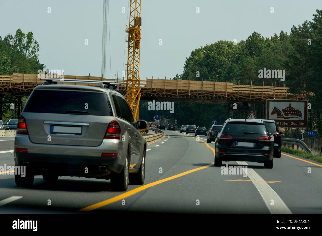 Various cars in a construction site area with construction crane on a german highway Stock Photo