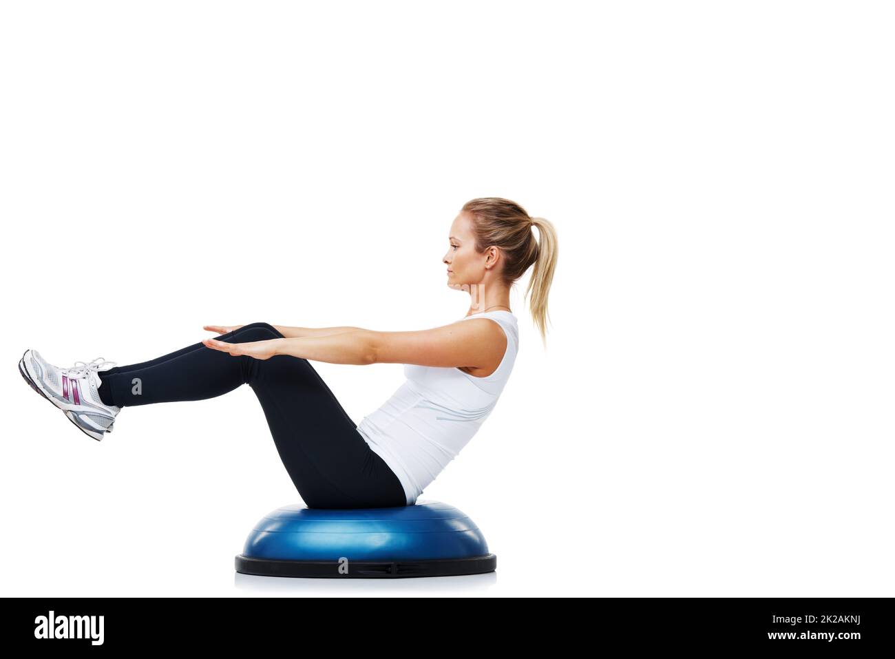 She loves working out and staying fit. A young woman balancing on a