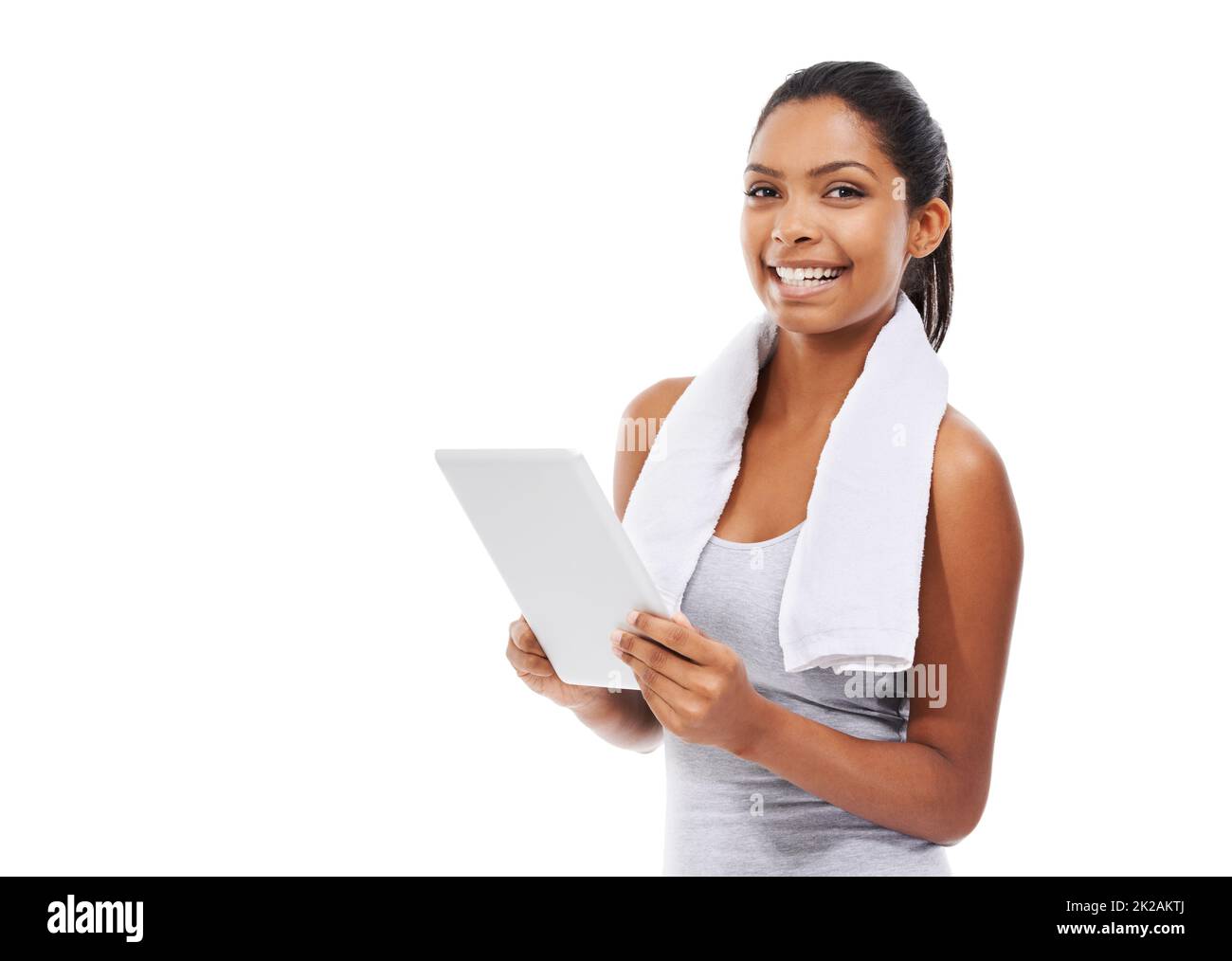 Using her tablet to monitor her fitness. A young woman in gym clothes working on a digital tablet. Stock Photo