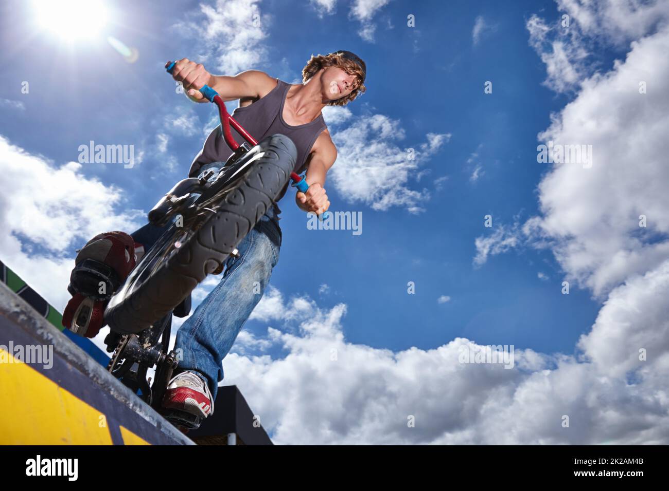Practicing for the x games. Full length shot of a teenage boy riding a BMX at a skatepark Stock