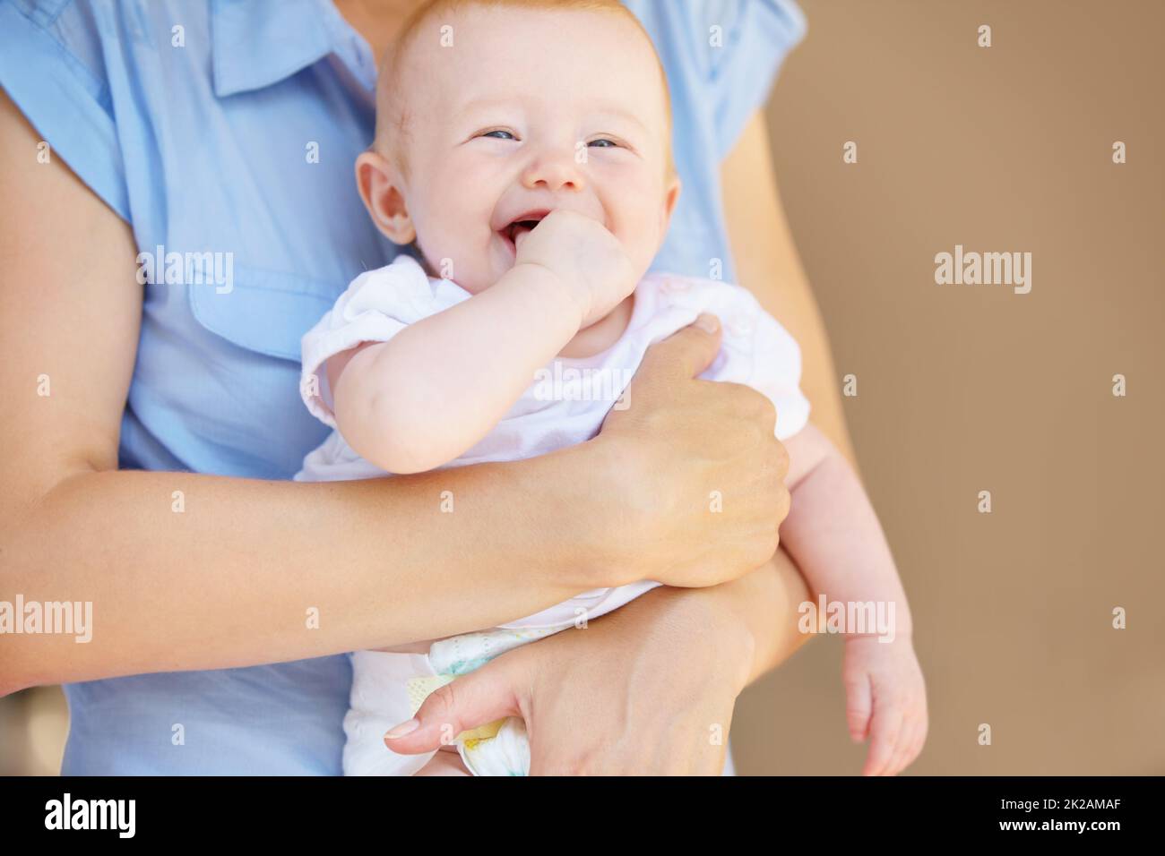 Little girl laughing happily. An adorable baby girl laughing while