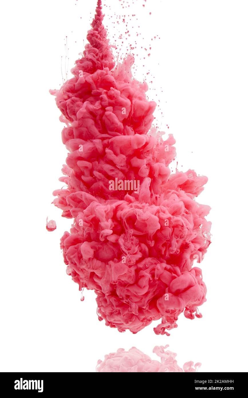 Its an explosion of color. Studio shot of pink ink in water against a white background. Stock Photo