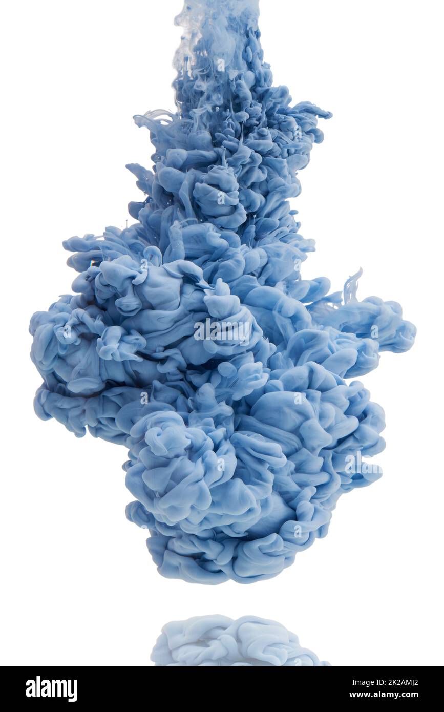 Its a colorful explosion. Studio shot of blue ink in water against a white background. Stock Photo