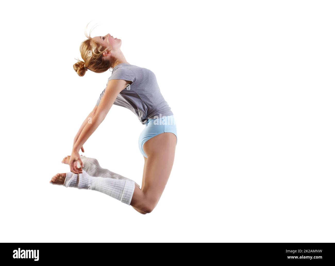 Filled with a desire to dance. Young dancer jumping against a white background. Stock Photo