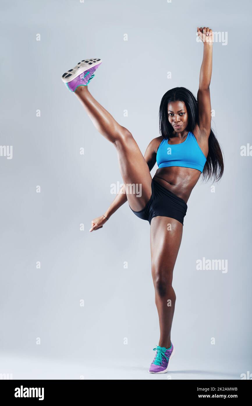 I used to be a cheerleader. A young woman in sportswear kicking up her leg. Stock Photo