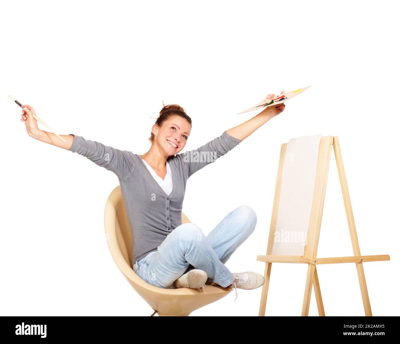 Searching for inspiration. Studio shot of a young woman holding a palette and brush looking for inspiration. Stock Photo