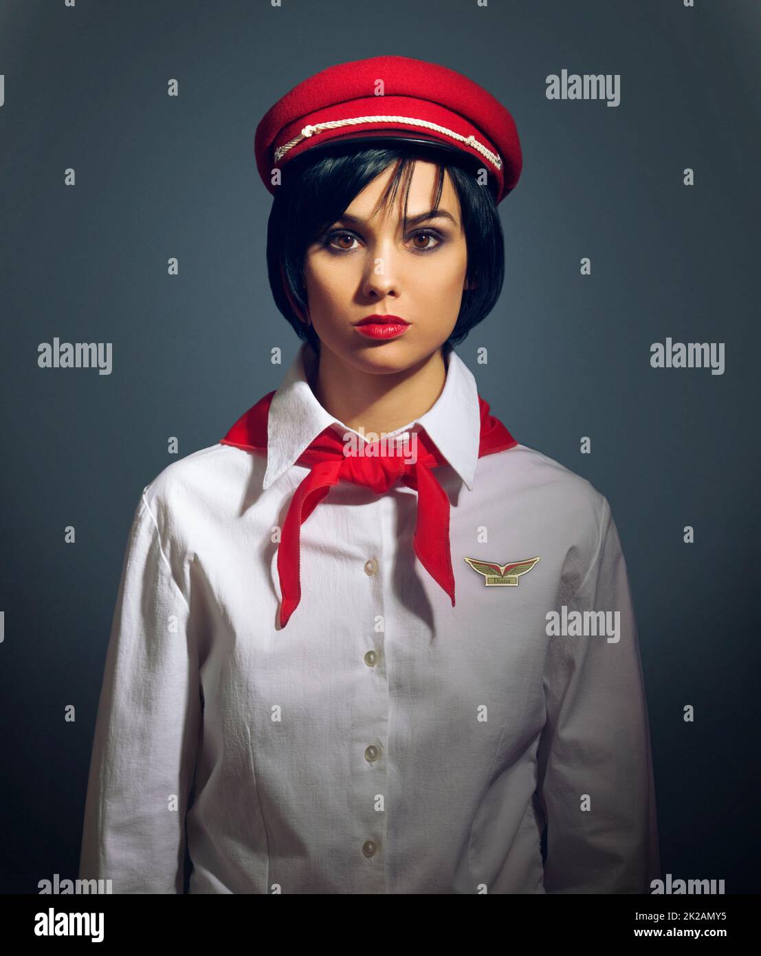 All aboard. Studio portrait of a woman dressed in a retro flight attendant uniform. Stock Photo