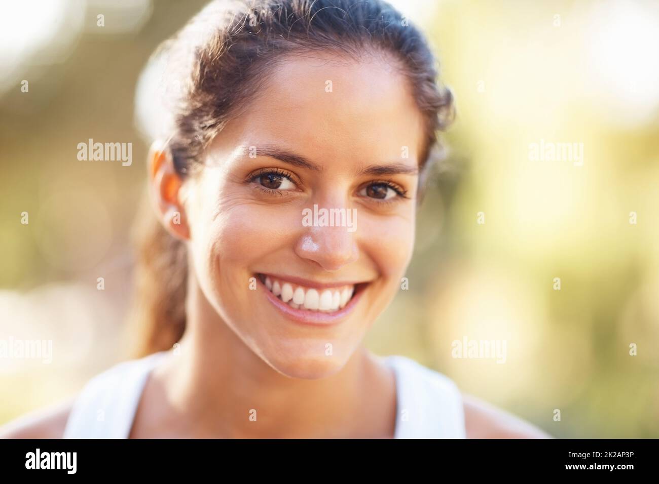 Woman giving a cute smile. Closeup of woman giving a cute smile. Stock Photo