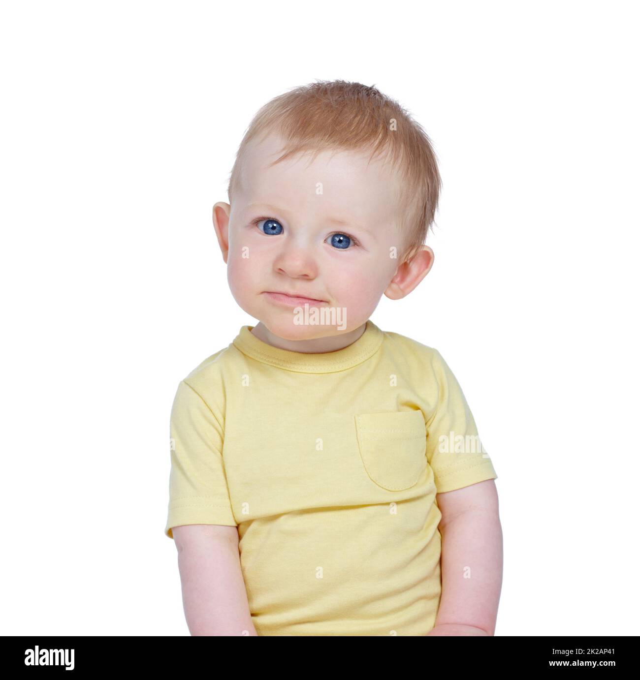 Curious kid. Studio shot of a cute baby boy in a yellow shirt. Stock Photo