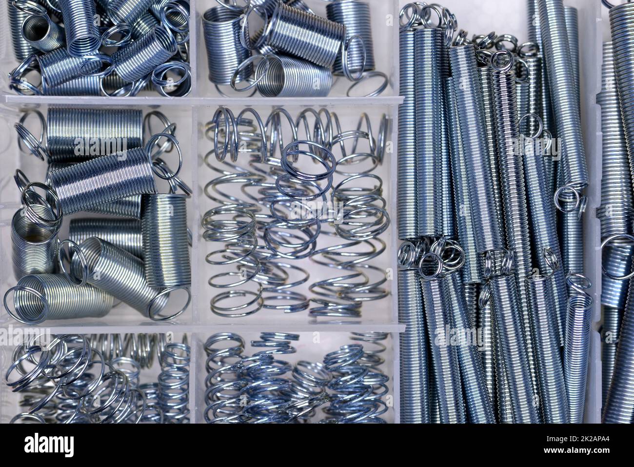 Metal springs in different sizes in a box Stock Photo Alamy