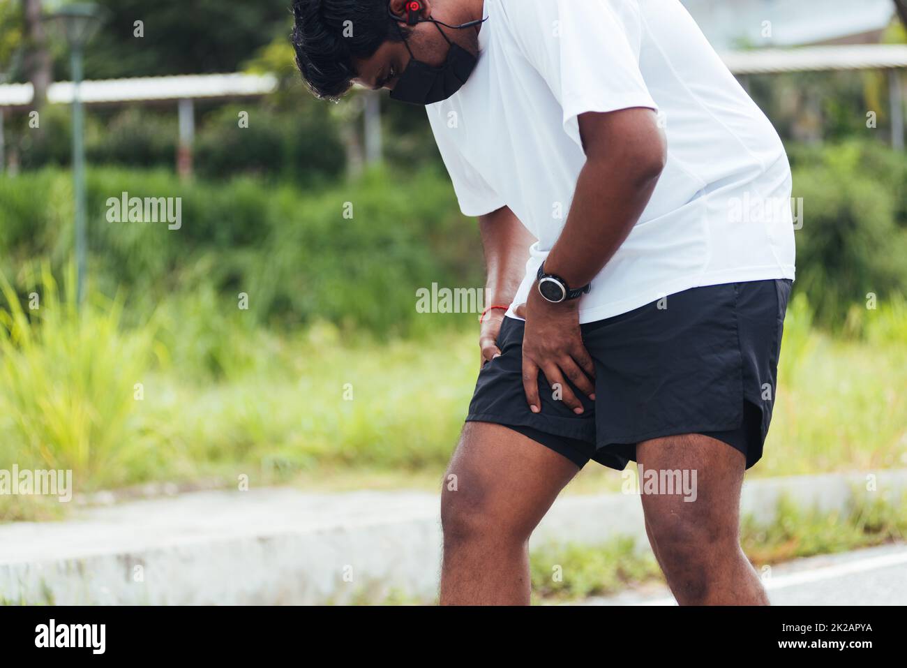 sport runner black man wear watch hands joint hold leg she has thigh