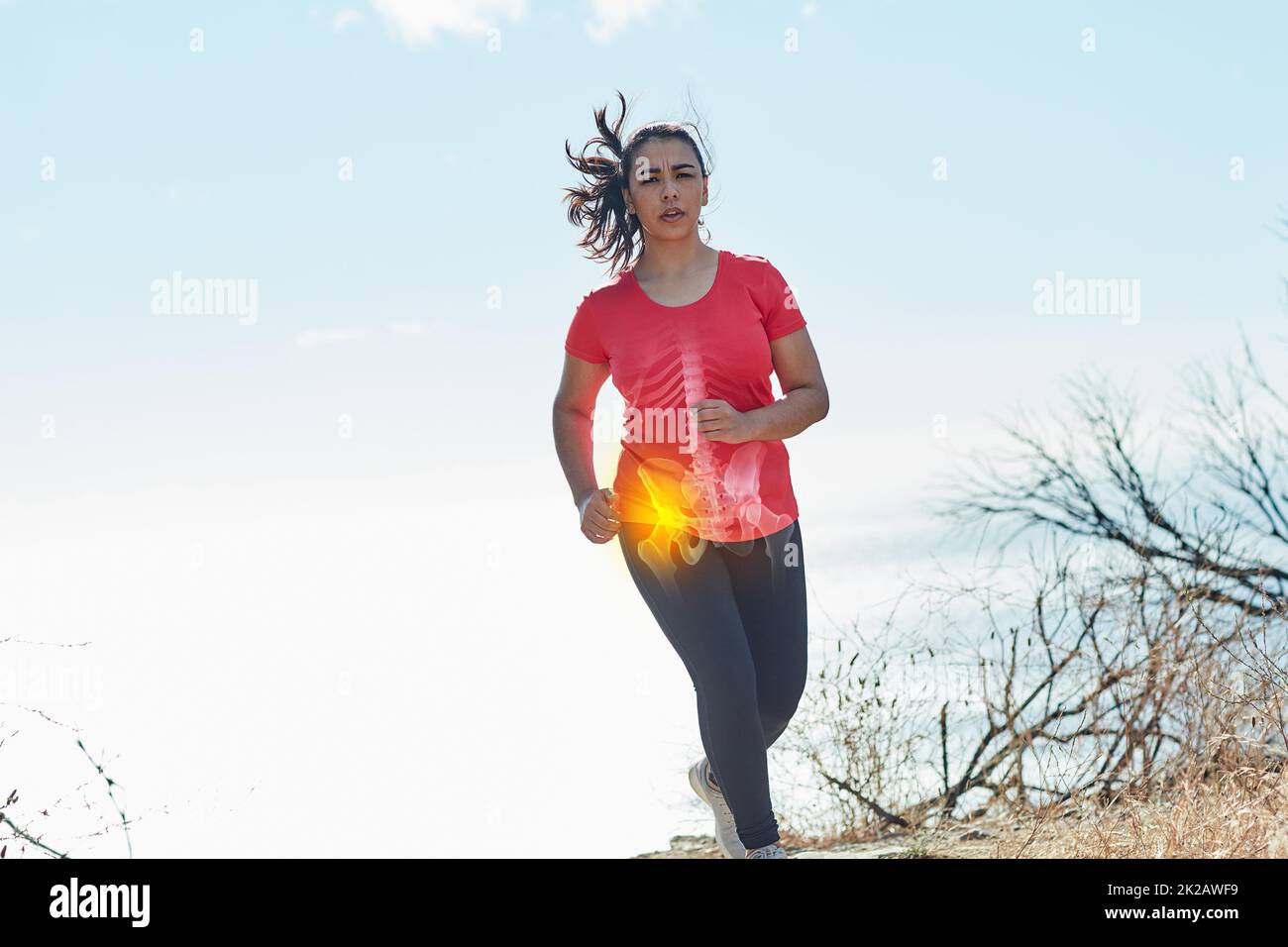 Pushing through the pain. Shot of an attractive young woman running
