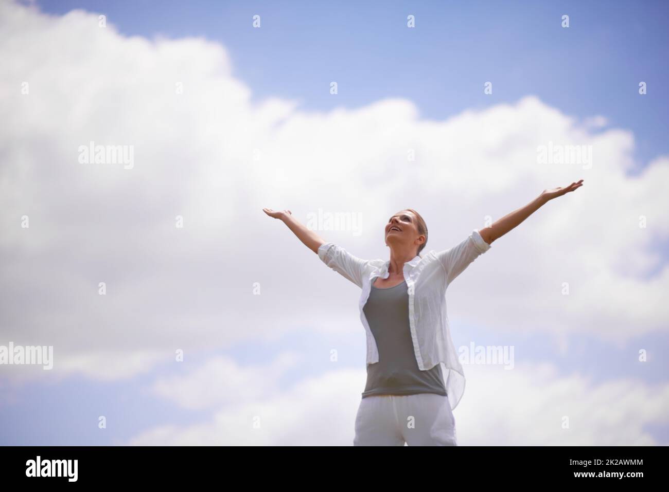 Enjoying life to the fullest. A mature woman with arms outstretched. Stock Photo