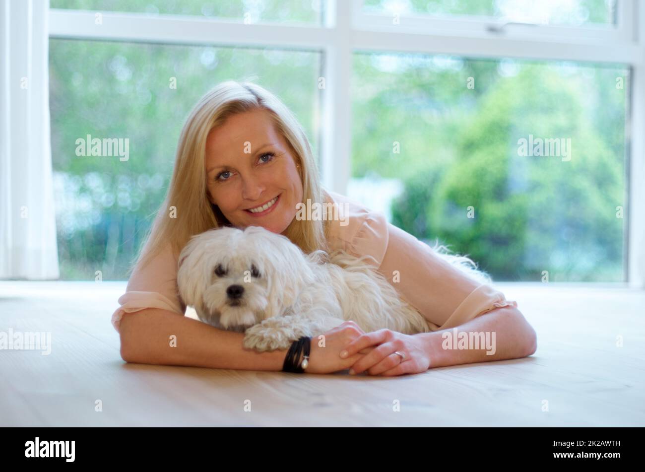 Womans best friend too. A woman bonding with her Maltese poodle. Stock Photo