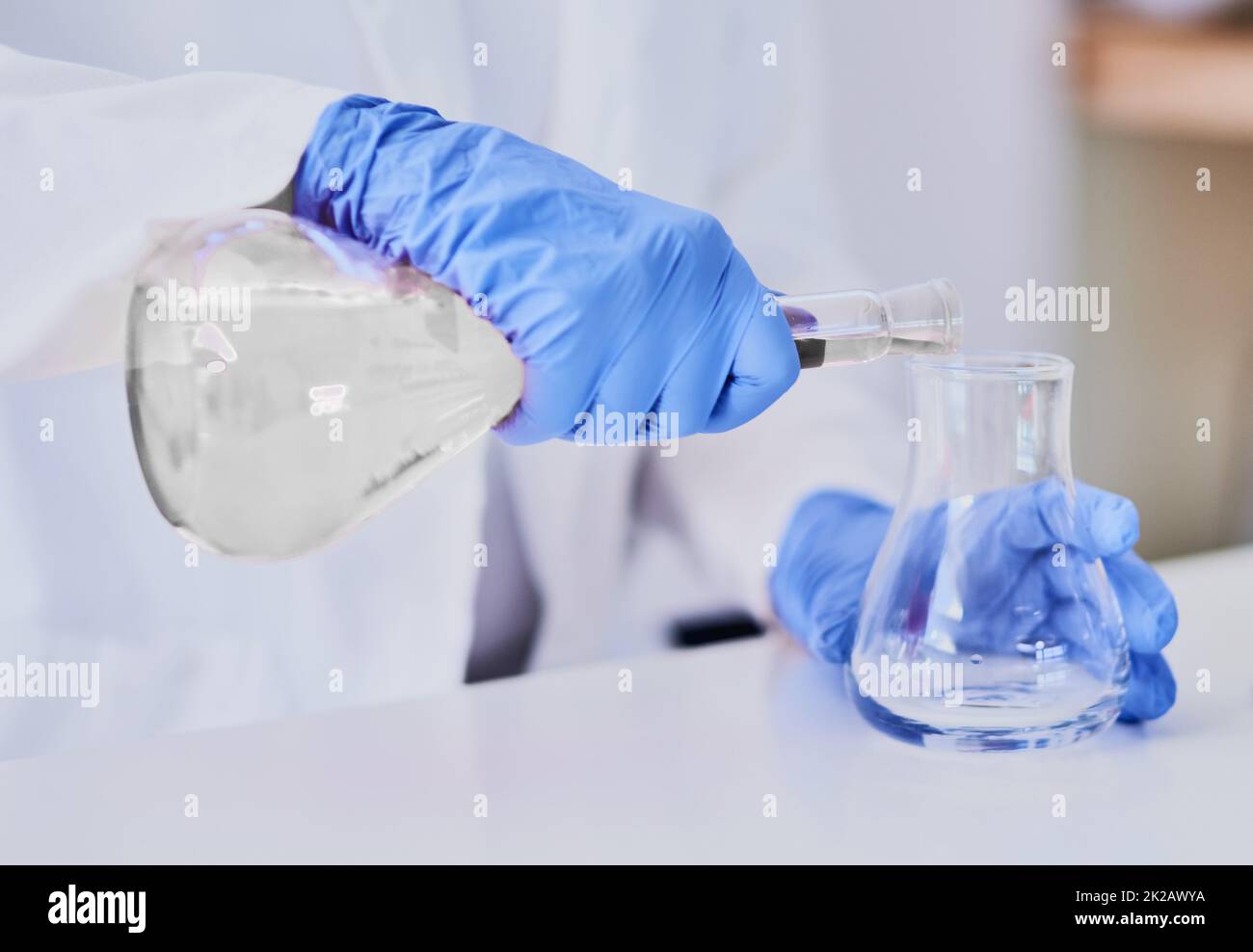 Discovering chemical reactions. Cropped shot of a scientist mixing chemicals in beakers while