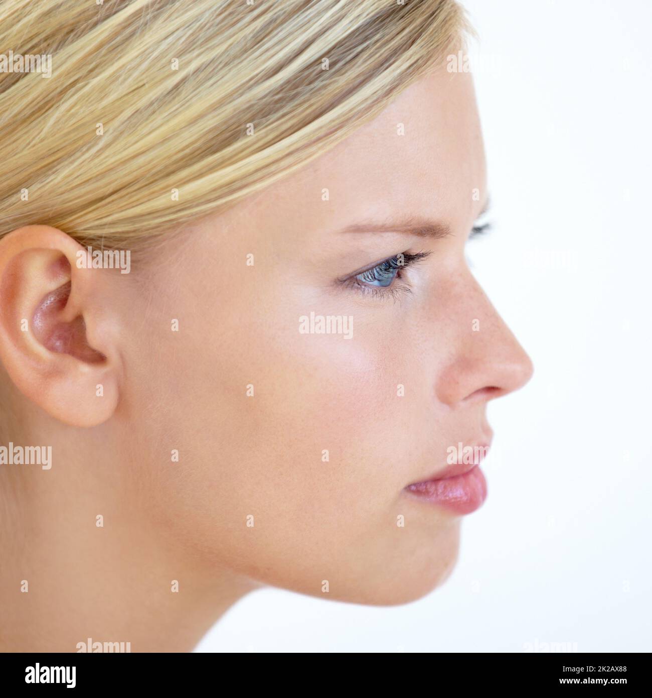 She has a stern presence. Closeup of a young woman looking serious. Stock Photo