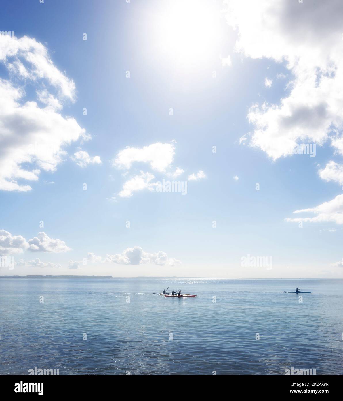 kayaking. An early morning photo of young people kayaking on the ocean