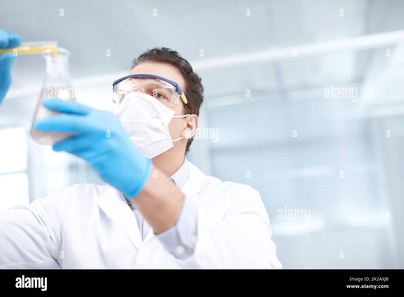 Lets see what happens. Low angle shot of a chemist mixing chemicals. Stock Photo
