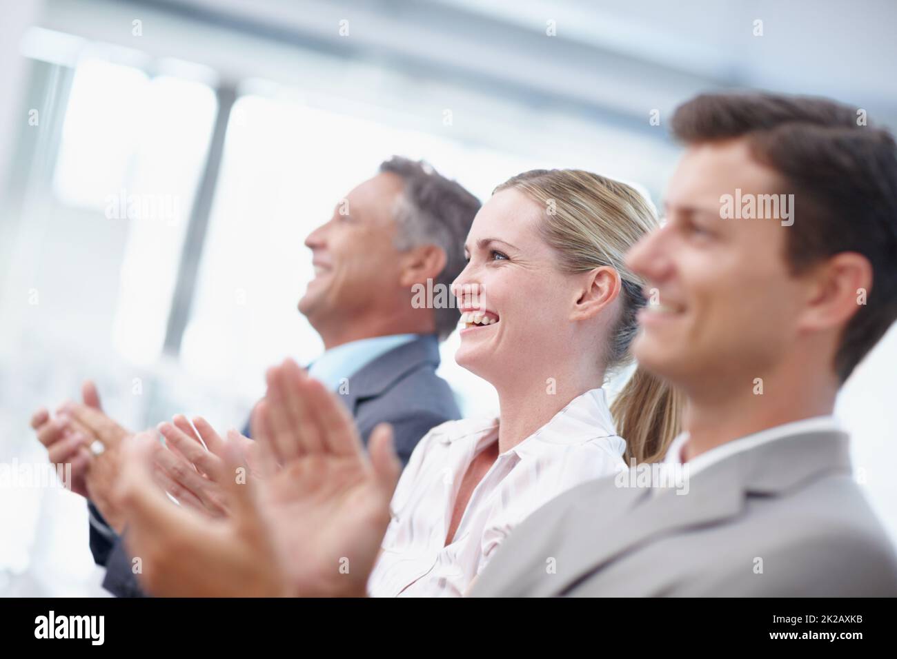 Bravo Brilliant. A trio of businesspeople applauding a brilliant presentation. Stock Photo