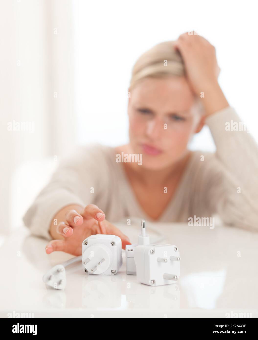 Dont pull the plug. Shot of a young woman reaching for power connection