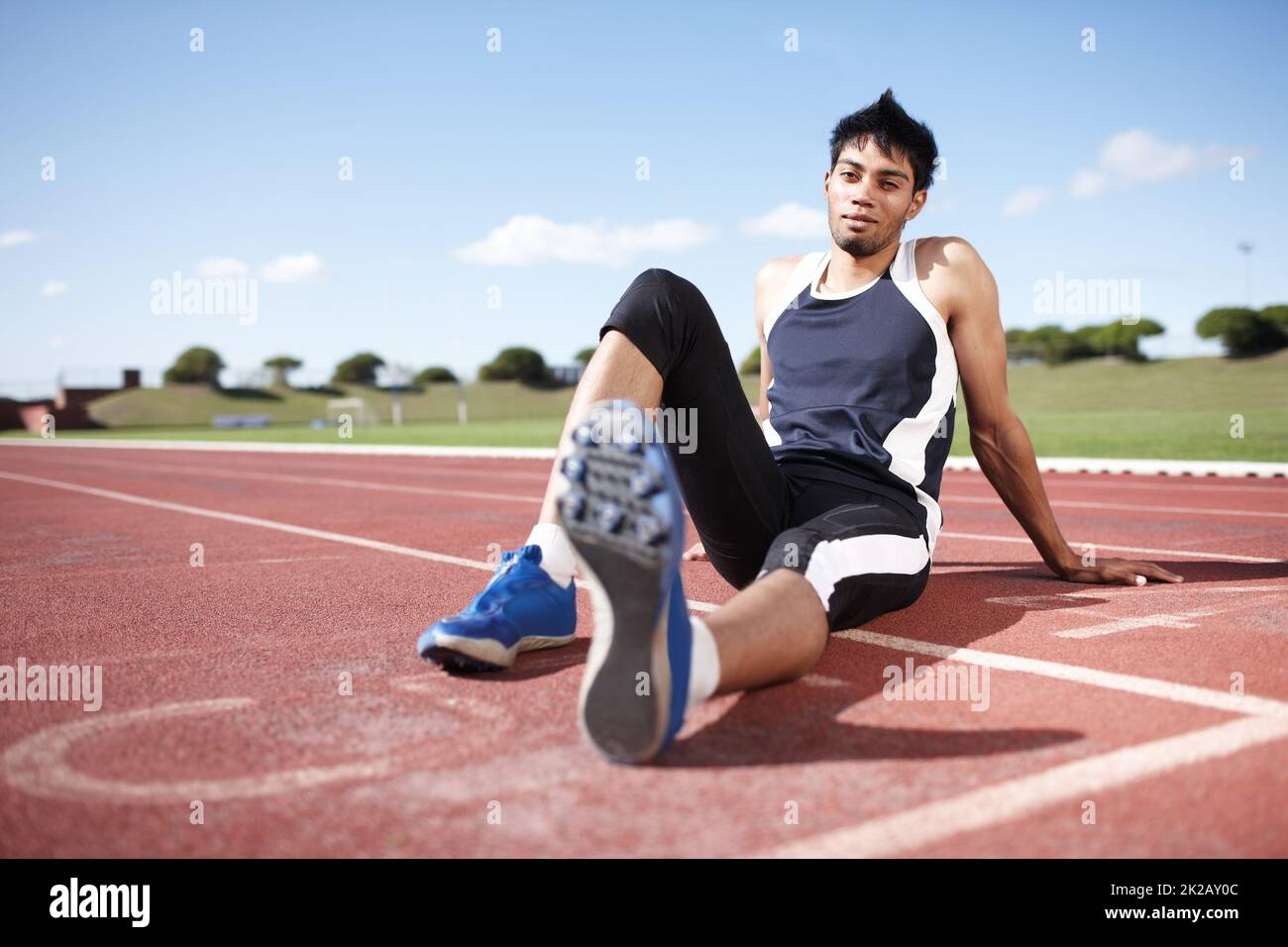 This is my turf. A young athlete leaning back on a running track. Stock Photo