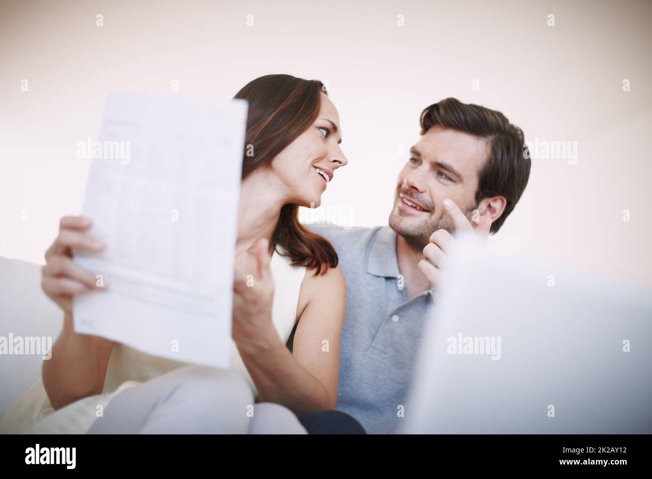 Were right on track. Low-angle view of a young couple animatedly discussing their home finances. Stock Photo