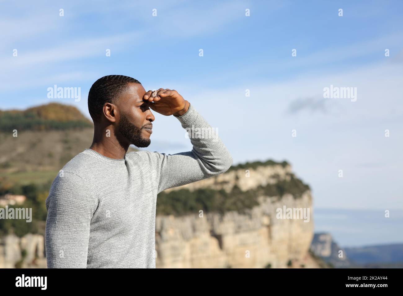 Man with black skin contemplating with hand on forehead Stock Photo