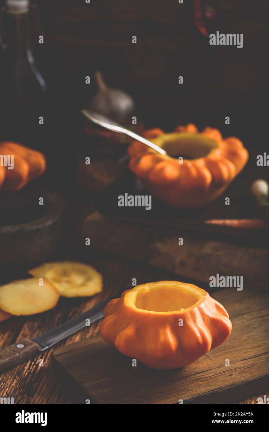 Preparing yellow pattypan squash for stuffing Stock Photo