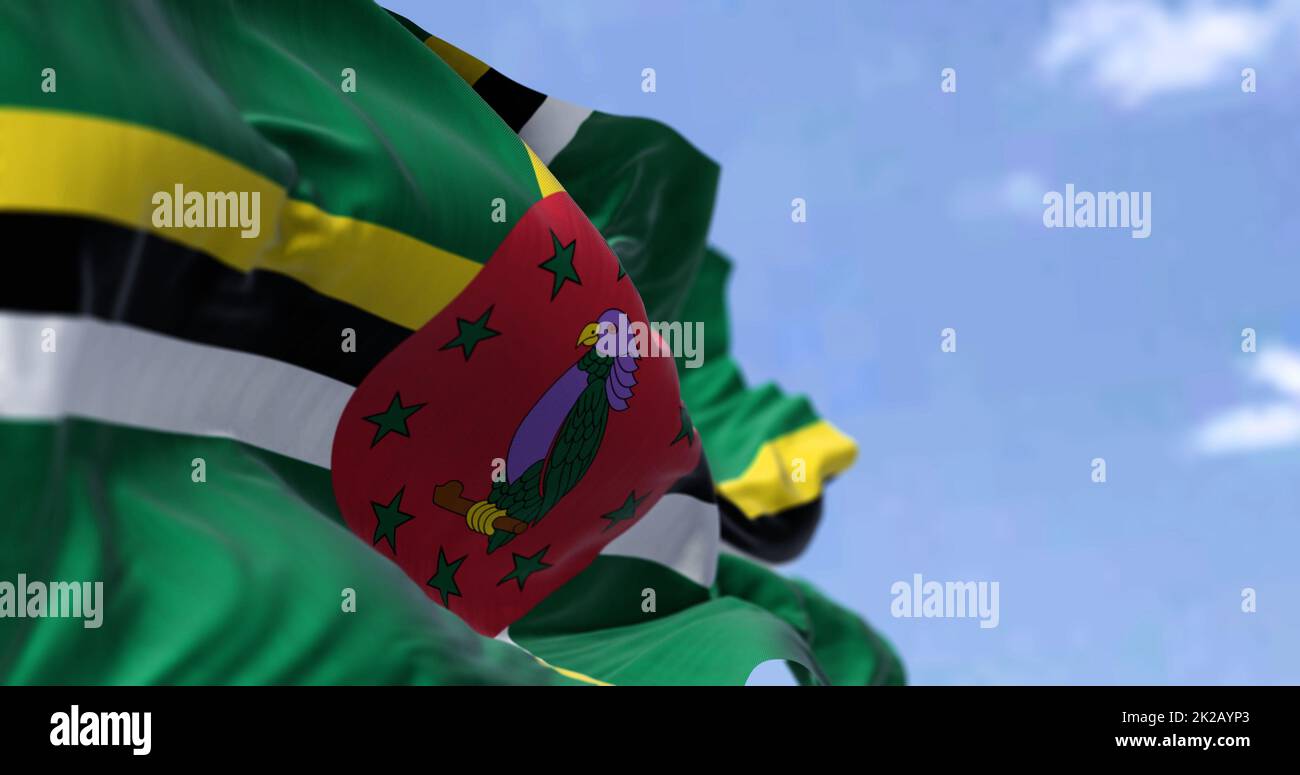 Detail of the national flag of Dominica waving in the wind on a clear day. Stock Photo