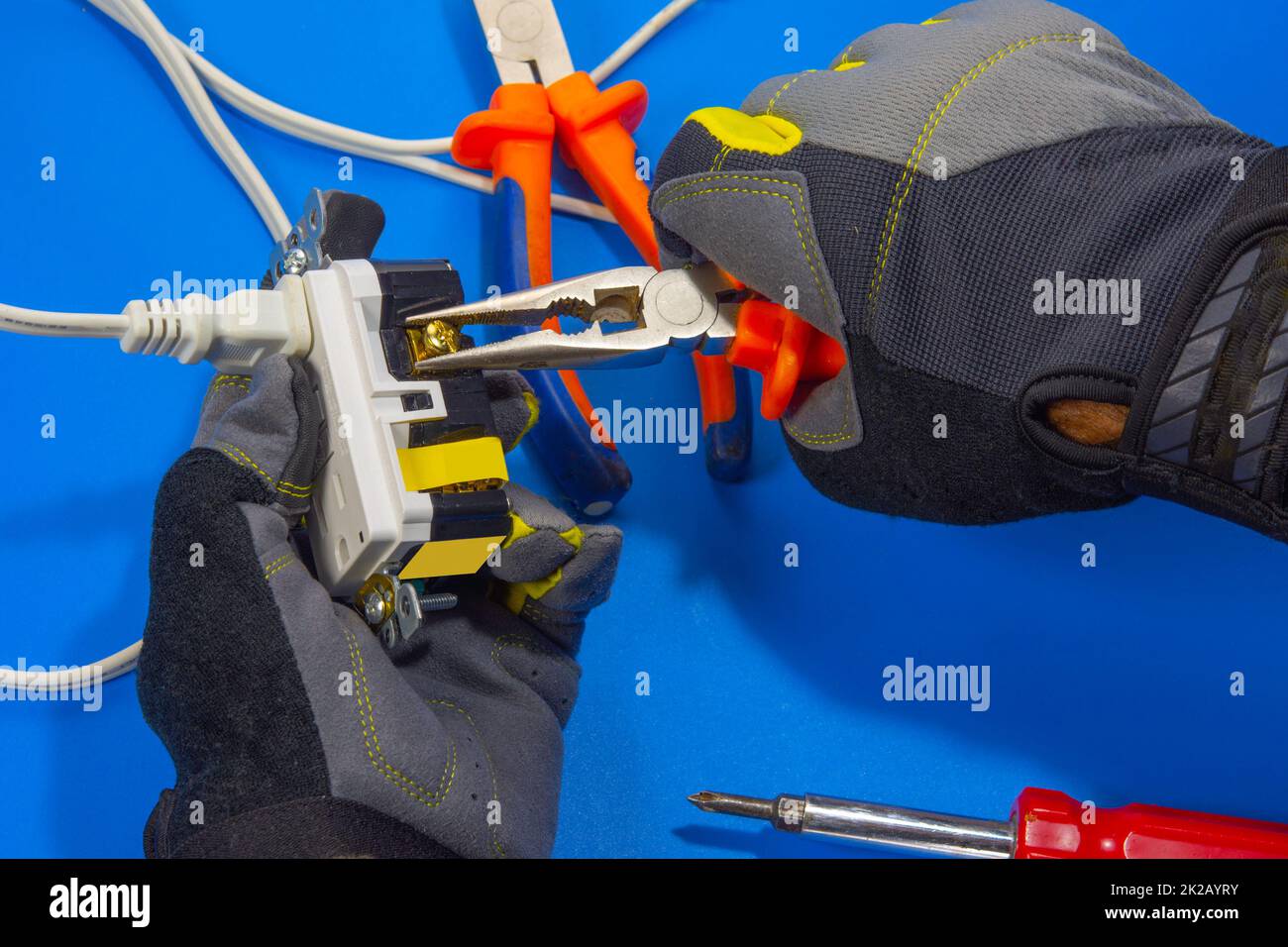 Electrician adjusts a screw on an electrical outlet Stock Photo Alamy