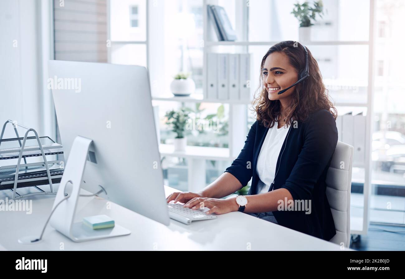 Answering every call with utmost professionalism. Shot of a young call centre agent working in an office. Stock Photo