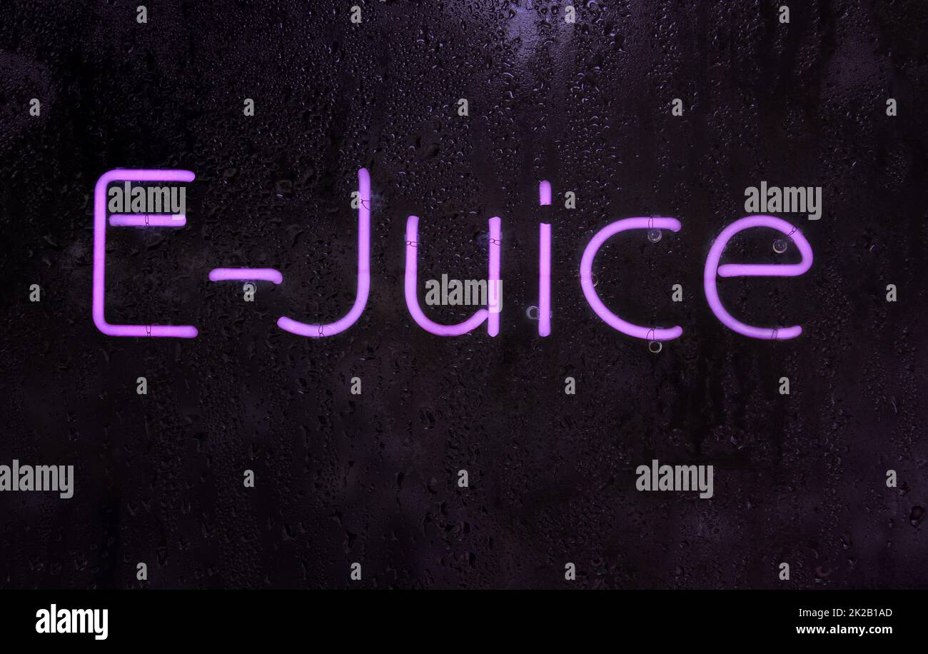 Purple Neon E-Juice Sign in Rainy Window Stock Photo