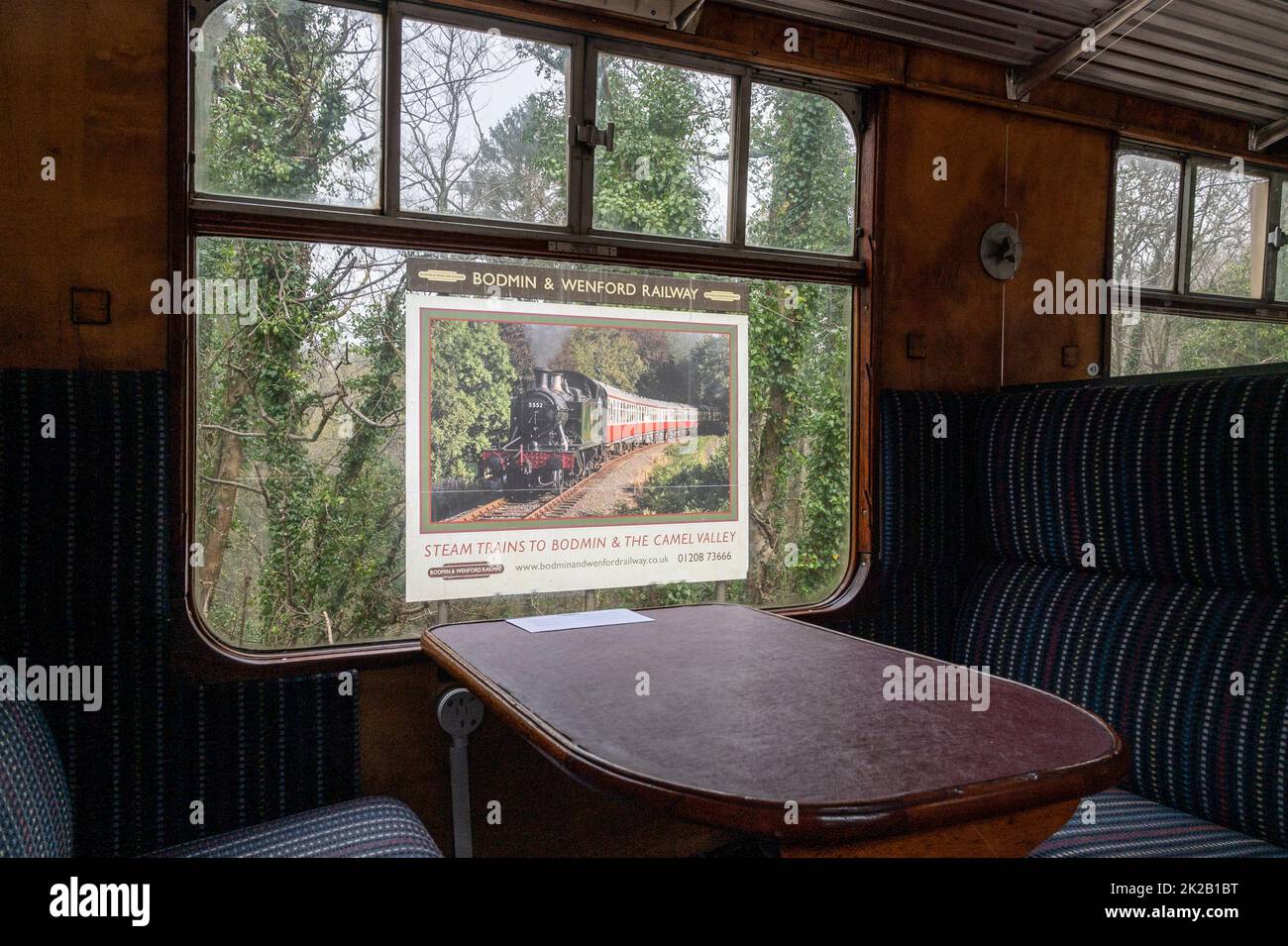 A poster advertising Bodmin and Wenford heritage rail from inside a GWR steam train carriage.  Cornwall, UK Stock Photo