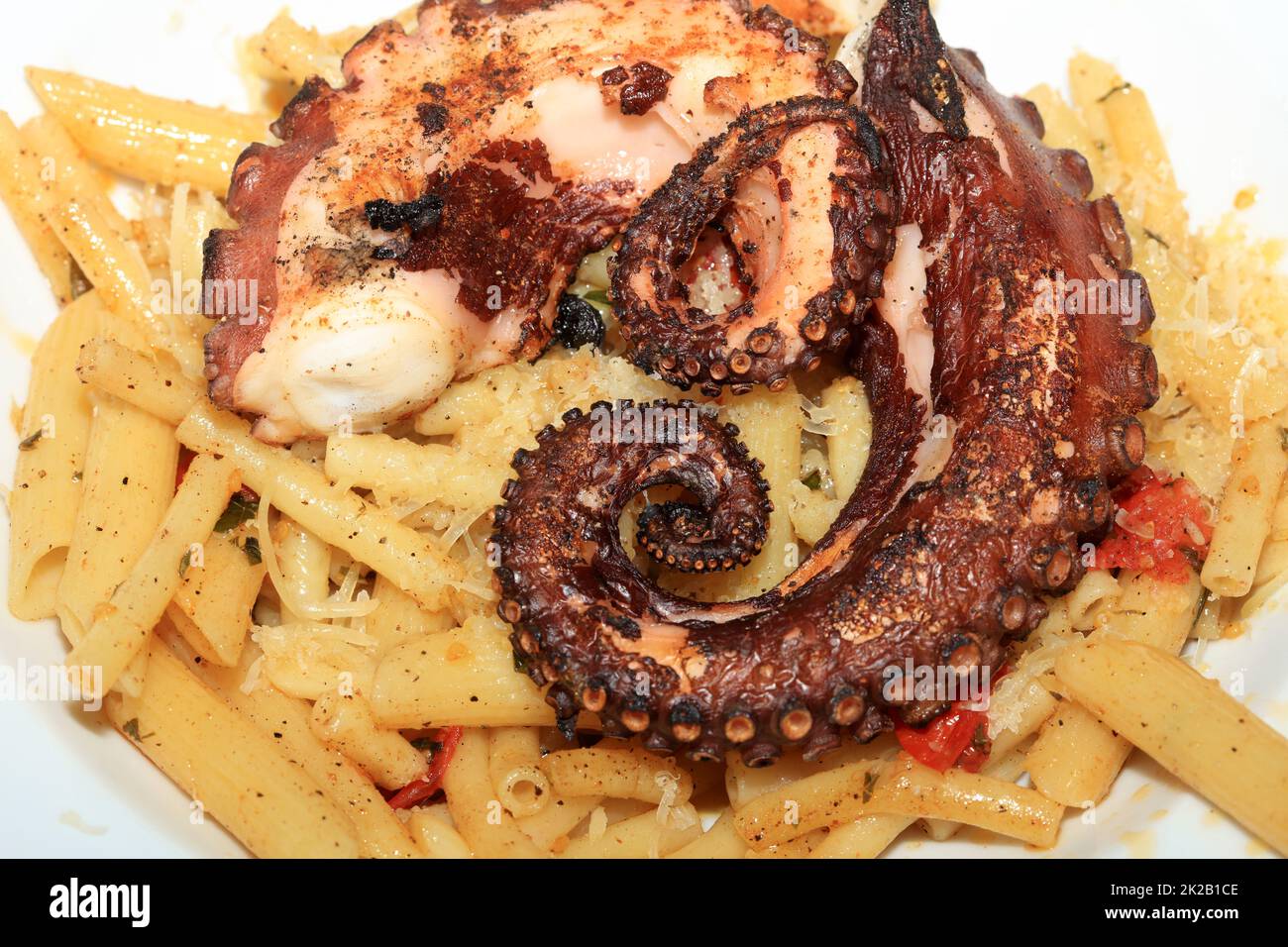 Italian Pasta with boiled Octopus on a Plate Stock Photo - Alamy