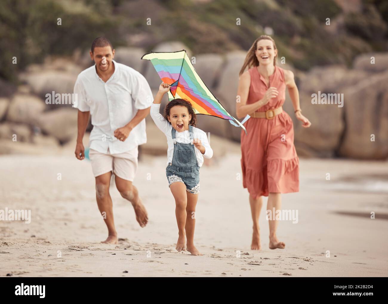 Happy family running on beach hi-res stock photography and images - Alamy